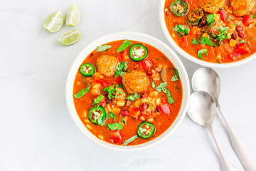 Albondigas Soup, Spanish and Mexican Food. Top view. Hot Soup with Meatballs and vegetables in a Bowl on the Table.