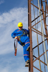 Electrician prepares safety belt to work on lamppost