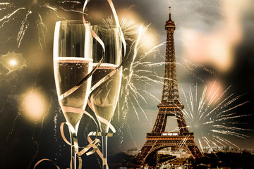 two glasses of champagne and Eiffel tower with fireworks New Year in Paris