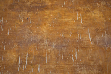 Grungy brown orange vintage painted wall.  Very old paint  background with cement stains. Visible...