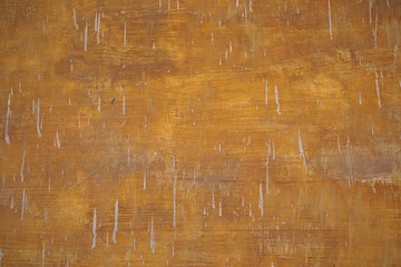 Grungy brown orange vintage painted wall.  Very old paint  background with plaster stains. Visible...