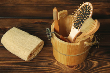 Bath set on a wooden background. Washcloth, razor, brush and comb