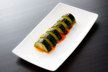 sliced cucumber with chilli oil in plate