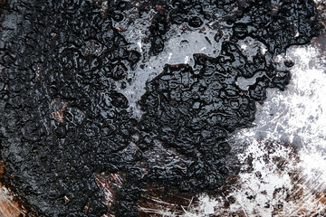 Burnt food in a pan. Cleaning the bottom with soot.