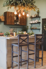 Festive interior in Christmas decorations. modern living room or dining room. Beautiful New Year decorated classic home interior. 