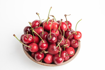 Obraz na płótnie Canvas Fresh Red Cherries In A Small Round Stoneware Bowl