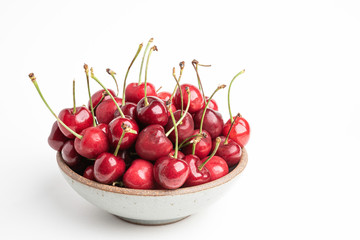 Fresh Red Cherries In A Small Round Stoneware Bowl