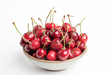 Fresh Red Cherries In A Small Round Stoneware Bowl