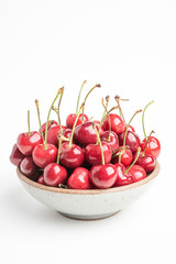 Fresh Red Cherries In A Small Round Stoneware Bowl
