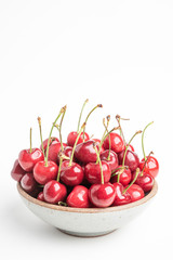 Fresh Red Cherries In A Small Round Stoneware Bowl