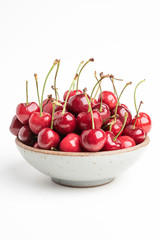 Fresh Red Cherries In A Small Round Stoneware Bowl