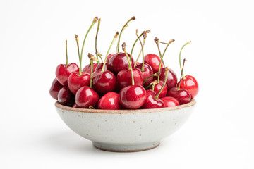 Fresh Red Cherries In A Small Round Stoneware Bowl