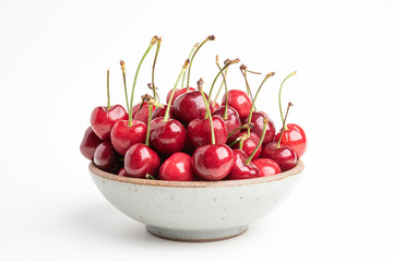 Fresh Red Cherries In A Small Round Stoneware Bowl