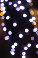 Defocused Christmas background with blue and gold colored bokeh lights.