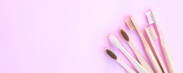 Ecological wooden toothbrushes on a pink background. Zero waste concept. Ecological product.