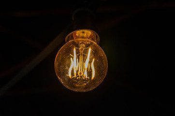 Incandescent light bulb illuminates the dark