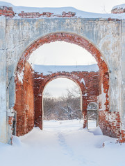 Arch in an old brick wall at winter