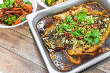 Sichuan Grilled Fish in red spicy oil. Authentic China Szechuan Chongqing food on table.