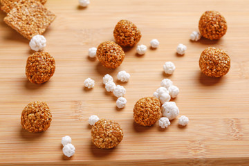 Til Gul OR Sweet Sesame Laddu with Fikri for Indian festival Makar Sankranti over wooden background 