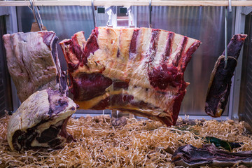 Display of Dry Aged Meat Steaks in butchers shop or restaurant in an display refrigerator.