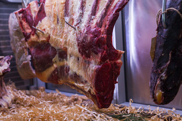 Display of Dry Aged Meat Steaks in butchers shop or restaurant in an display refrigerator.