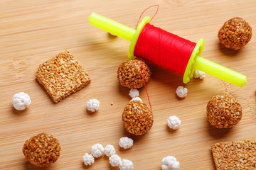 Til Gul OR Sweet Sesame Laddu with Fikri for Indian festival Makar Sankranti over wooden background 