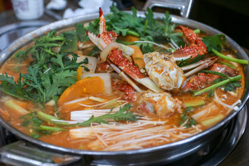 Top view of Korean food hot spicy Crab Stew Soup, Kkotgetang, served in a restaurant