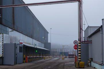 Entrance to the territory of a large modern warehouse. Industrial warehouse for shipment and...
