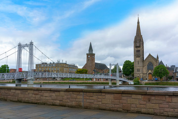 Fototapeta na wymiar View of Greig Street Bridge with the Free North Church of Scotland in the background across the River Ness in Inverness, Scotland