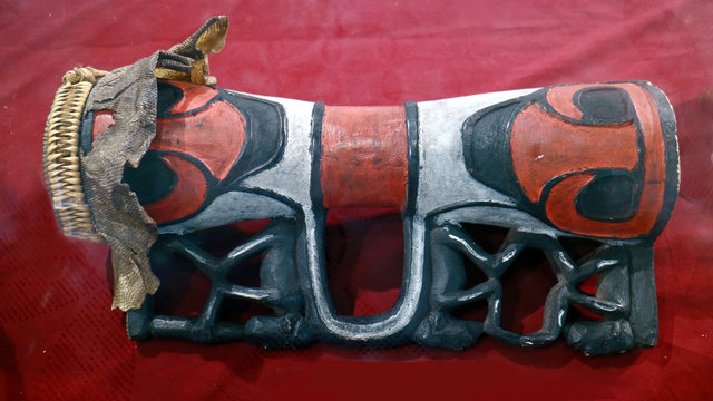 Tifa on red background. Tifa is a musical instrument that originated from Maluku and Papua, Tifa much like the way drums are played with a hit.    