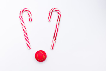 christmas candy and red ball like deer on white background, copy space