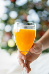 woman holding glass of orange juice