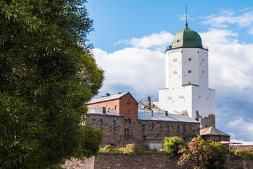 Fototapeta premium Beautiful view of the Vyborg Castle in sunlight on the background of cloudy sky, Vyborg, Leningrad Oblast, Russia