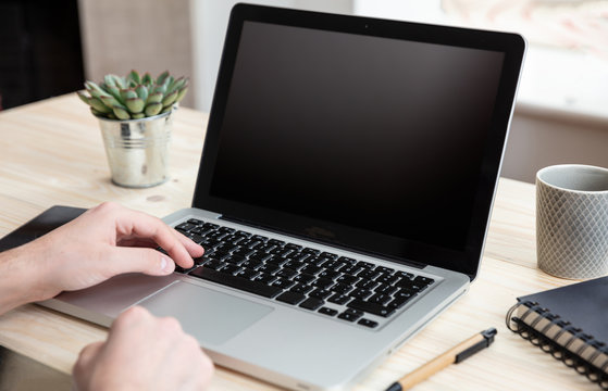 Computer Laptop With Black Blank Screen On A Wooden Desk