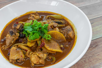Stir-fry spicy chicken with sliced potato and dried chillies. Authentic China Chinese Sichuan food on table.