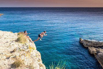 Croatia, Istria, Pula, Cape Kamenjak, man jumping from a cliff