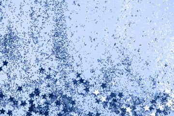 confetti and stars and sparkles on Classic Blue Christmas background. Top view, flat lay. Copyspace for text. Bright and festive holiday background. Color of year 2020.