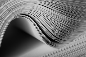 Close-up of a bending stack of paper - obrazy, fototapety, plakaty