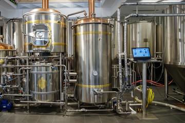 Stainless steel brewing tanks and equipment, iron reservoirs and pipes in modern beer factory