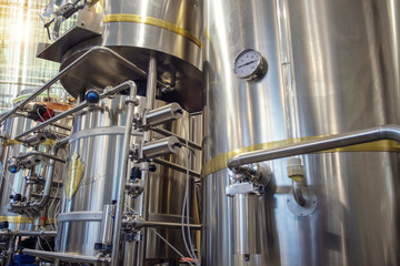 Stainless steel brewing tanks and equipment, iron reservoirs and pipes in modern beer factory