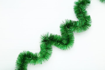 Christmas tinsel on white wooden table