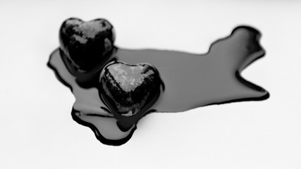 two black hearts in black paint on white background