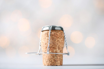 Wine cork with metal cap on blurred background