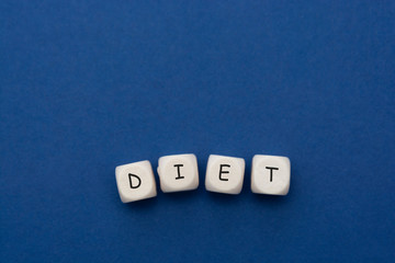 "Diet" words written on wooden blokcs over clasic blue background. Memory, health and concentration. Copy space.