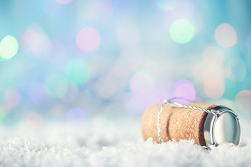 Wine cork with metal cap on blue blurred background