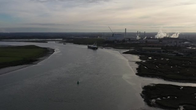 Wide pullback rising aerial orbit view of Kemsley Industry in Kent, UK