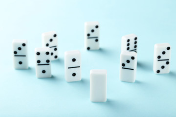 Leader concept. Domino tiles on blue background