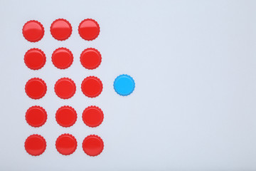Bottle caps leader on grey background