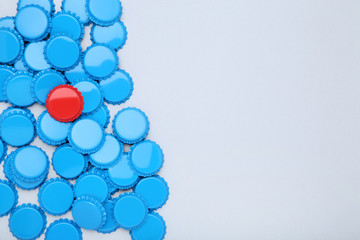 Bottle caps leader on grey background