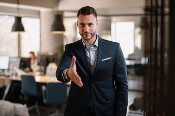 Businessman gives a hand for handshaking	